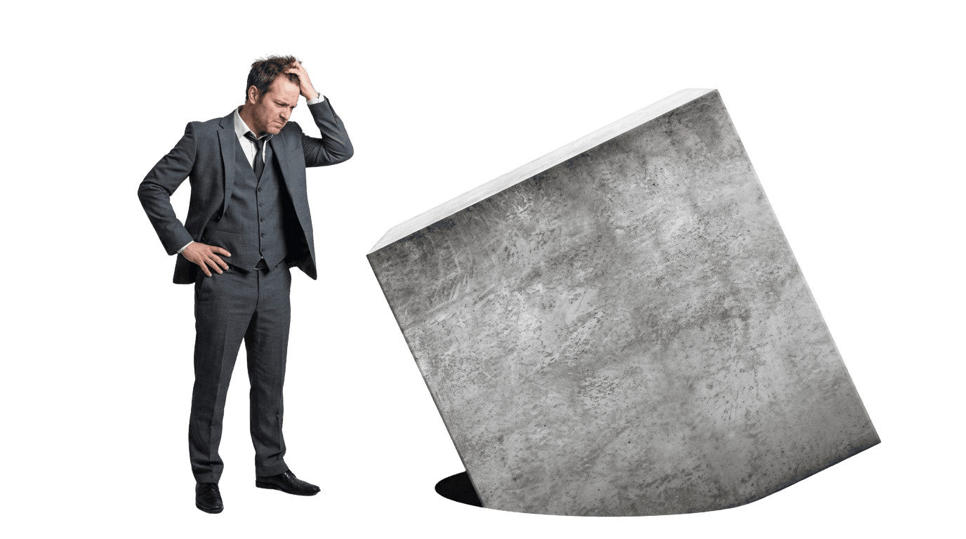 Businessman frustrated trying to fit a square block into a round hole